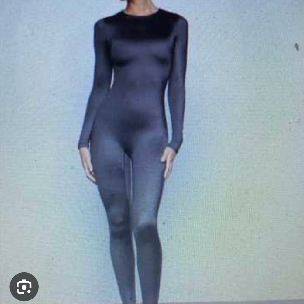Skims shiny black catsuit